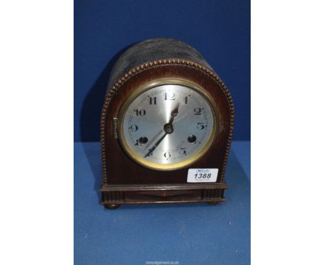 A wooden cased domed Mantle clock, with key and pendulum, 6 1/2" wide x 8" tall.