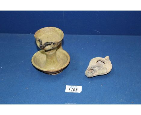 A fine early Islamic terracotta oil lamp, 12-13th century with traces of a cream-coloured transparent glaze and extensive evi
