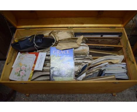 A plywood trunk filled with various sheet music and other items