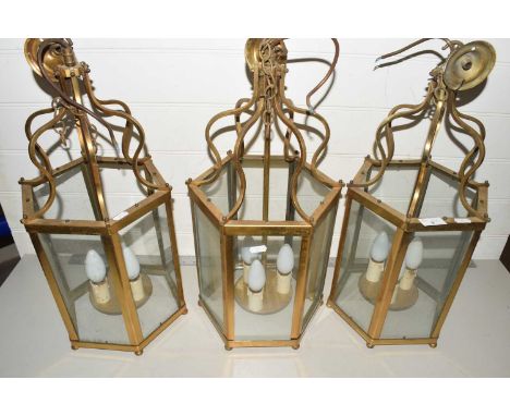 A set of three 20th Century hexagonal brass and glass lantern style light fittings