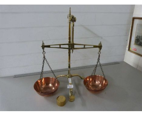 A pair of brass and copper bank scales together with a brass £5 weight