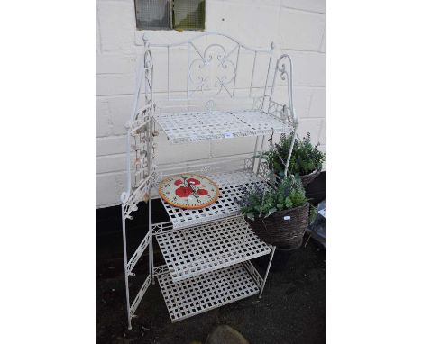 White painted metal garden shelf together with simulated hanging baskets