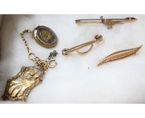 A 9ct gold stick pin with pheasant decoration and metal pin, an 18ct gold leaf brooch marked, 750, 1.4g another 9ct gold stic