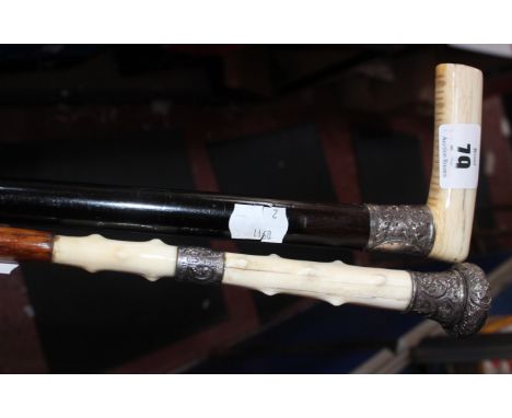 An ebony, bone and silver mounted walking cane, 82cm and a bamboo and silver mounted swagger stick, 91cm (2)