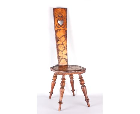 An early 20th Century Welsh Spinner's chair with foliate decoration, the seat centred by initials and dated below 