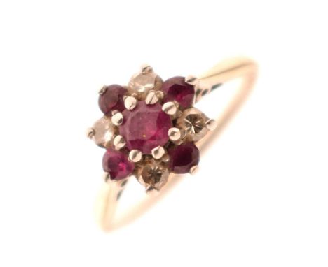 Ruby and diamond nine-stone cluster ring, the white metal mount stamped 'Plat 18ct', size L½, 2.6g gross approx