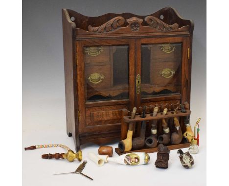 Edwardian smoker's oak cabinet, the two bevelled edge glazed doors revealing single compartment flaked by drawers, 41cm wide 
