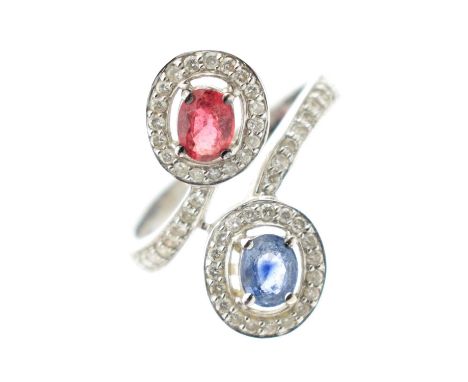 18ct white gold ruby, sapphire and diamond crossover dress ring, the two principal stones claw set within a border of diamond
