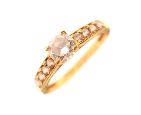 Single stone dress ring, four-claw set a brilliant cut white stone, each shoulder set with four smaller stones, hallmarked 22