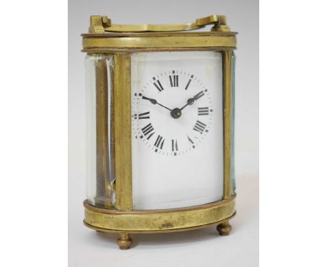 Early 20th century French oval brass cased carriage timepiece, the rectangular white enamel black Roman dial with spade hands
