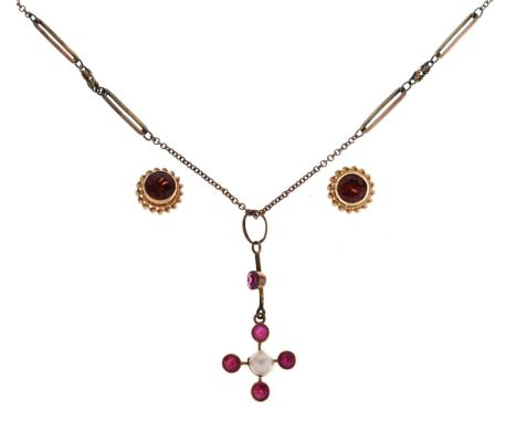 Early 20th century ruby and seed pearl cruciform pendant, suspended on a knife-edged bar set a ruby, 35mm long approx, on a y