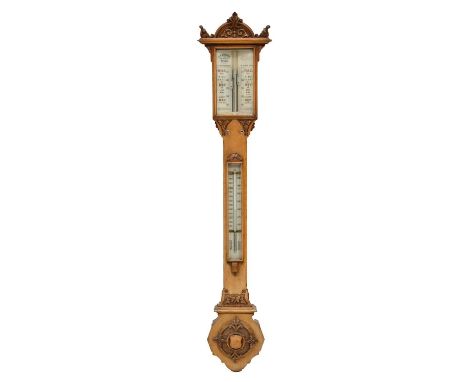 Late Victorian carved oak stick barometer by J. H. Steward, London, the arched glass scale reading from from 27 to 31 inches 