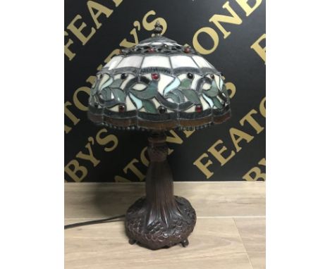 REPRODUCTION TIFFANY-STYLE TABLE LAMP the shade with floral and roundel detail overall, set on a copperised shaped base