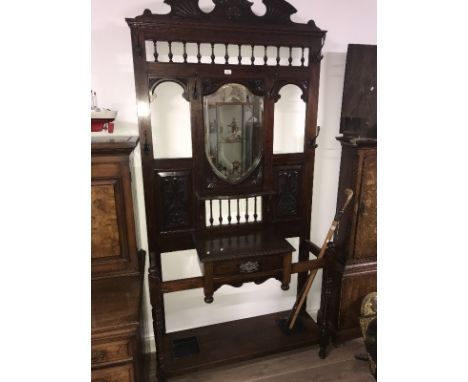 VICTORIAN MAHOGANY MIRRORED BACK HALLSTAND with centre shield-shaped bevel edged mirror below shaped pediment and bobbin frie