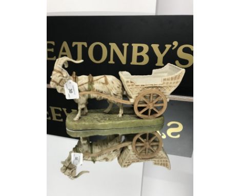 ROYAL DUX GOAT AND CART ORNAMENT decorated in pastel tones with gilt highlights, set on shaped base, pink triangle mark and i