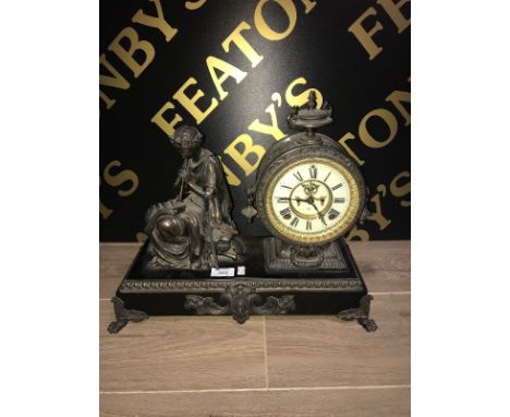 VICTORIAN FRENCH MOVEMENT FIGURAL MANTEL CLOCK the enamelled dial with Roman numerals in circular copperised case flanked by 