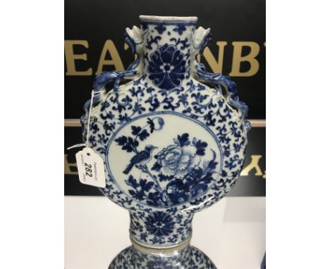 19thC CHINESE BLUE AND WHITE MOON FLASK decorated with figures within a floral border, finished with dragon handles, height 2