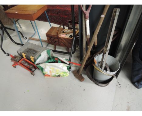 A selection of tools including pail and trolley jack