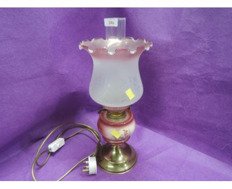 A vintage converted oil burning lamp with etched and pink frosted shade