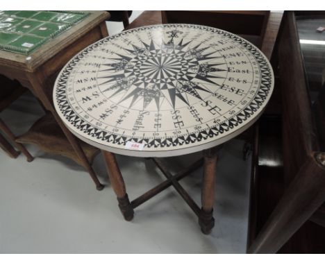 A vintage occasional table having compass design