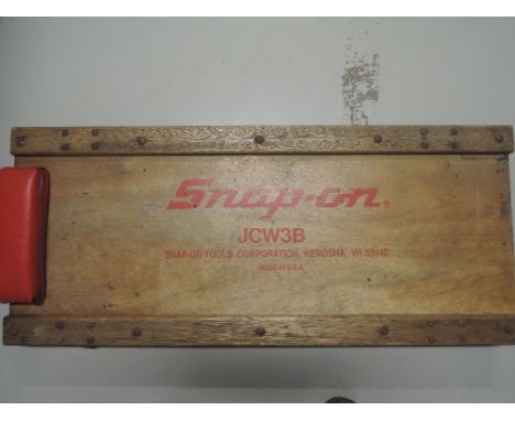 A vintage mechanics car creeper advertising Snap-on tools 