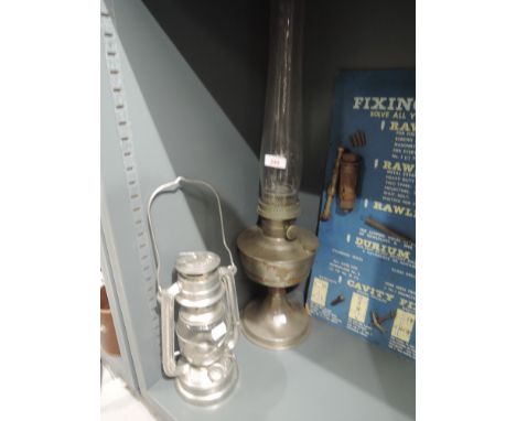 A vintage Super Aladdin oil burning lamp and similar storm lantern