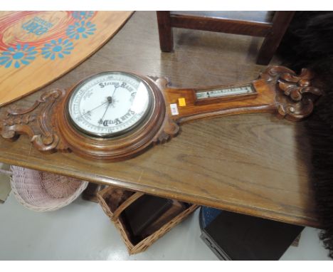 An early 20th Century oak cased banjo barometer with thermometer scale