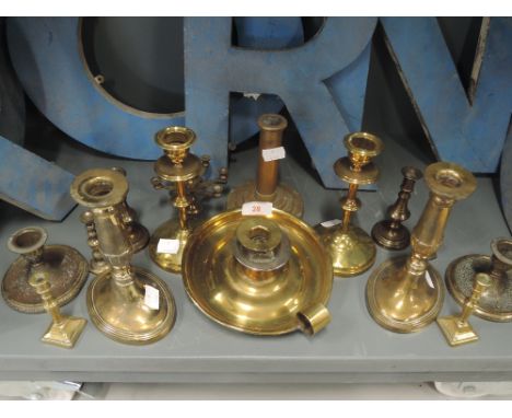 A selection of vintage brass cast candle and chamber sticks
