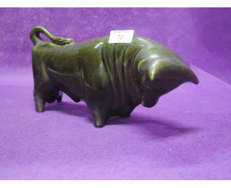 A vintage ceramic money box in a stylised Spanish bull design with green glaze 