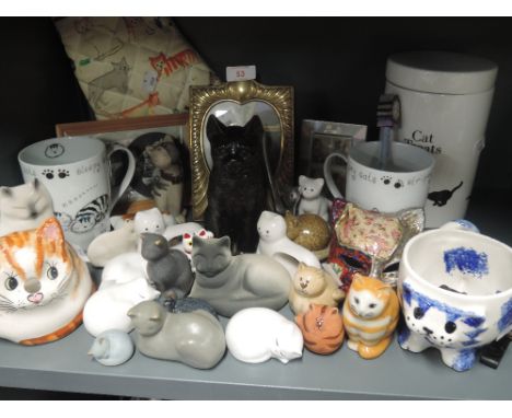 A selection of vintage cat themed figures and trinkets