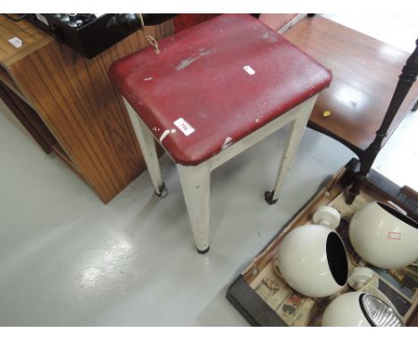 A vintage metal frame stool