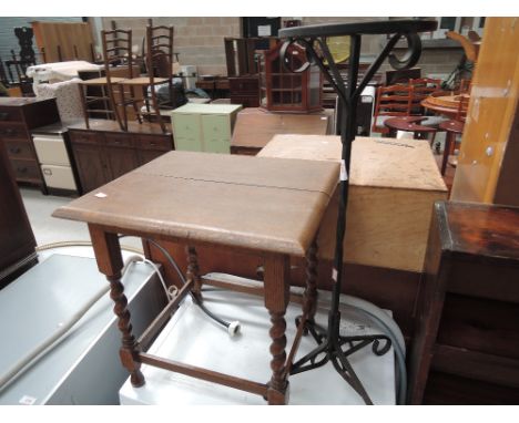 A wrought iron stick stand and an oak occasional table