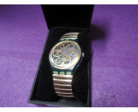 A vintage gentleman's wrist watch clock by Swatch Swiss with pierced metal visible inner 