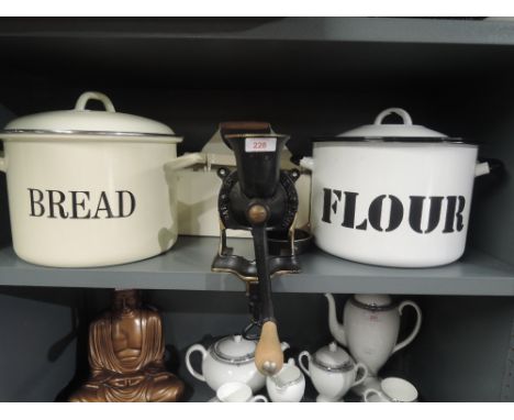 A selection of vintage kitchen items including enamel flour and bread bins