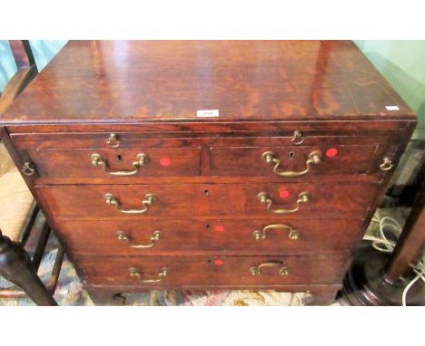 An early 19th century oak bachelors chest of small proportions, the rectangular top over brushing slide, two short and three 