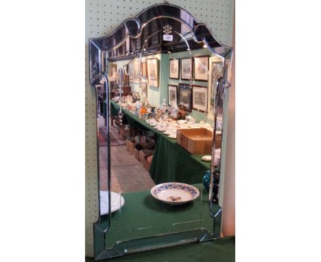 A 20th century Venetian-type wall mirror, having bevelled swept tinted glass peripheral plates around a central plate, decora