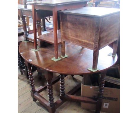An oak drop leaf gateleg dining table with twin demi lune flaps,on bobbin turned and block supports, together with an oak com
