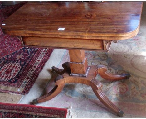 A Regency mahogany card table, the D-shaped fold-over swivel top on a square beaded column, quatrefoil plateau and four reede