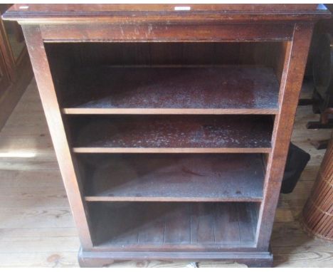 An early 20th century oak four tier open bookcase on bracket feet.