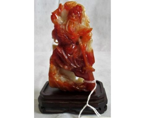 A piece of Oriental carved russet and mutton fat jade, in the form of the rampaging God of War.   Condition Report:  Overall 