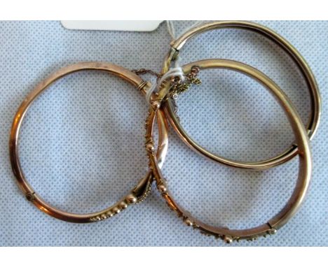 A 9ct gold rose gold bangle, the applied filigree work, another marked 9ct and a gilt metal bangle.
