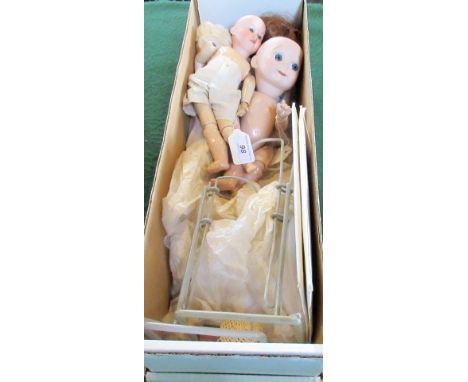A collection of porcelain head and composition bodies dolls, to include: a German made Kewpie doll with animated eyes, an Arm