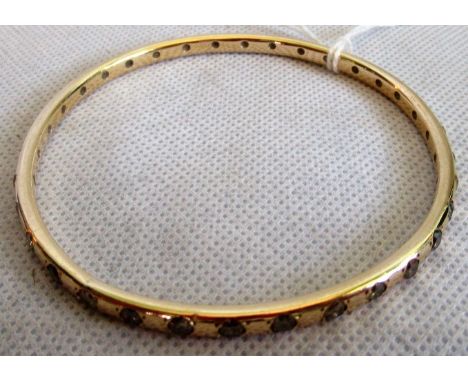 A diamond set bangle, the polished band set throughout with mixed brilliant cut diamonds.