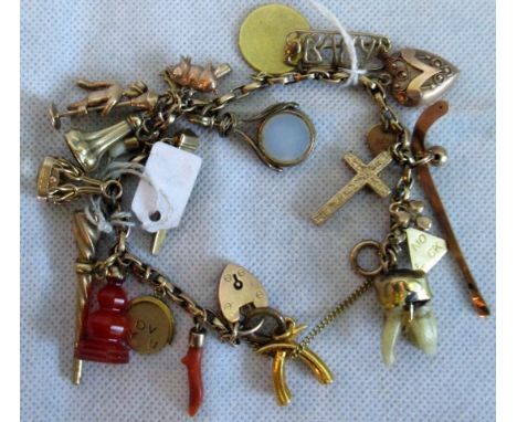 A charm bracelet with padlock clasp, suspending numerous charms, including a chimney sweep, some fob seals and watch keys.