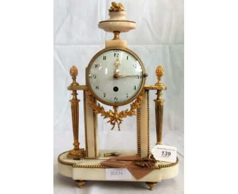 A late 19th century French eight day white marble and gilt metal drum head Portico clock, fitted with a silk suspended pendul