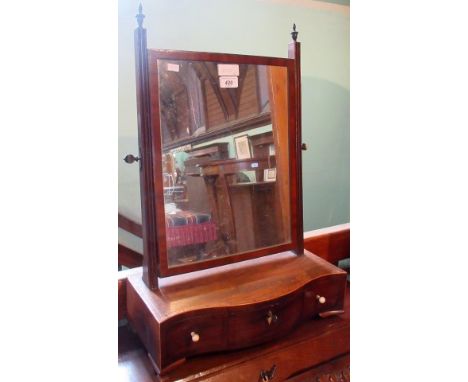 A 19th century toilet mirror, the rectangular plate within reeded horns with urn finials on a serpentine base fitted three dr