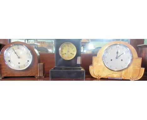 A collection of three mantle clocks, to include: late 19th century French black marble eight day mantle clock by Rollin of Pa