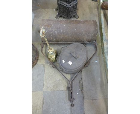 A cast iron garden roller, cooking pot and a Victorian cast iron door stop