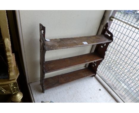 A small mahogany wall shelf