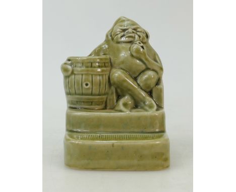 Doulton Lambeth Stoneware figure of a seated man with barrel smoking pipe: Stoneware figure by Harry Simeon in light green co